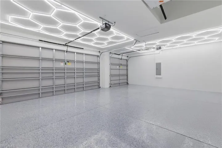 Garage with electric panel and a garage door opener