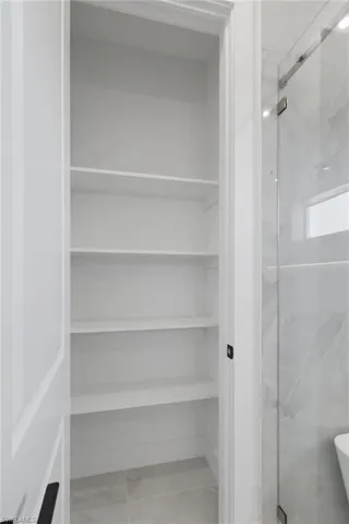 Bathroom with a marble finish shower