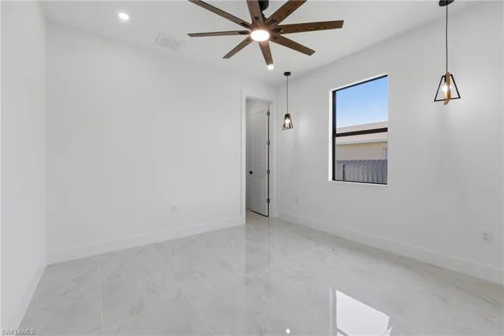 Spare room with recessed lighting and a ceiling fan