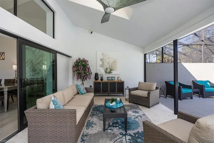 Sunroom with ceiling fan and vaulted ceiling
