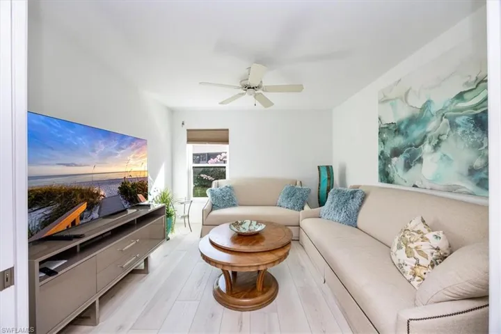 Living room featuring ceiling fan and light hardwood / wood-style flooring