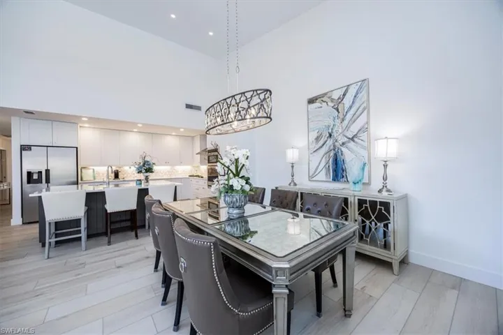 Dining room featuring a high ceiling and an inviting chandelier