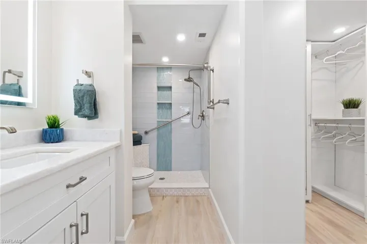 Stunning marble countertops, white shaker cabinets, shower fog-free mirrors, custom glass tile, walk-in shower, and custom walk-in closet