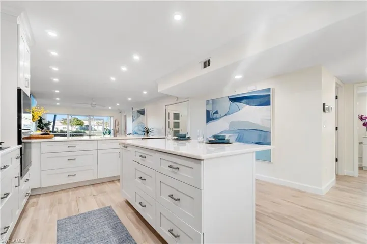 Completely redesigned to open floor plan, featuring white shaker cabinets, and soft-close, dovetail drawers and cabinets.  and light wood-like luxury vinyl flooring