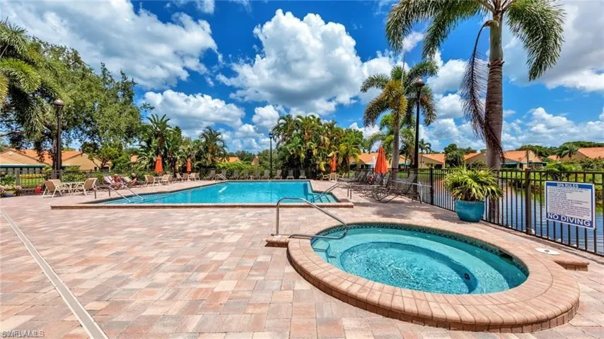 Community pool with a community hot tub and a patio area