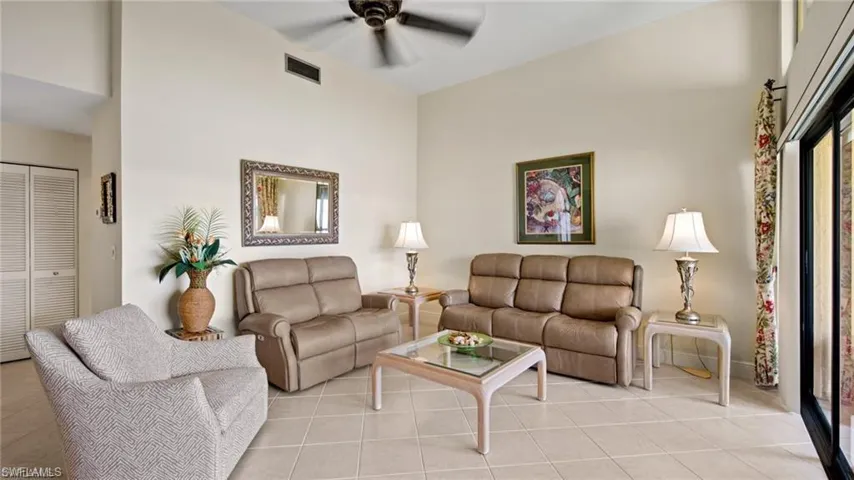 Living room featuring ceiling fan and light tile patterned flooring