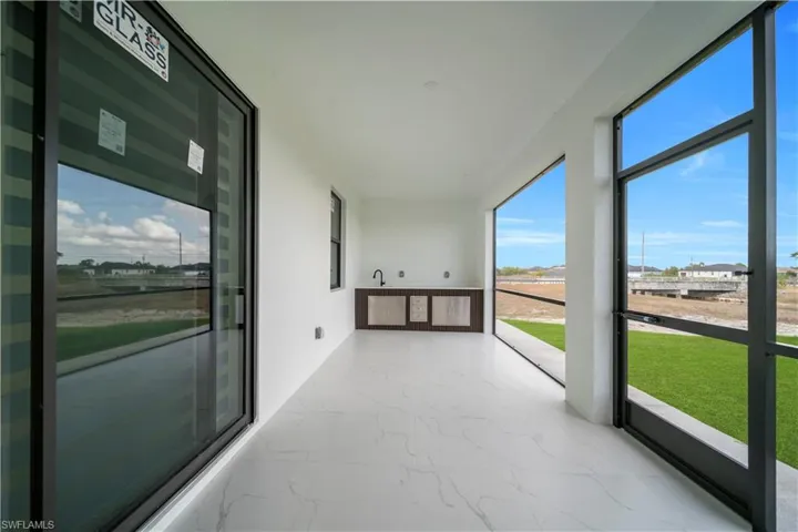 Unfurnished sunroom featuring marble finish flooring