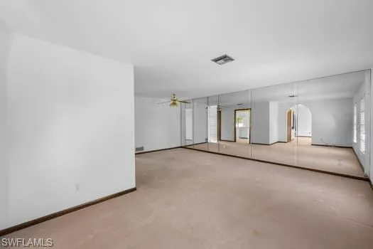 Empty room with concrete flooring and arched walkways