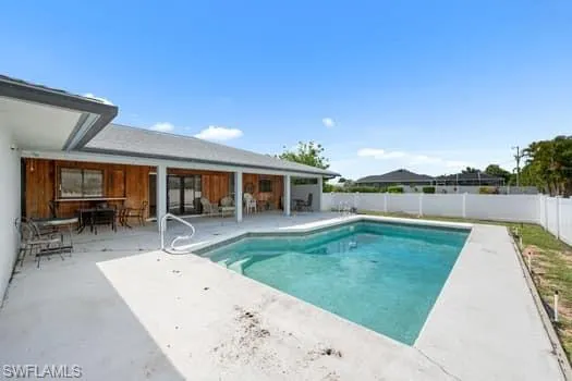 View of pool featuring a patio area and a fenced backyard