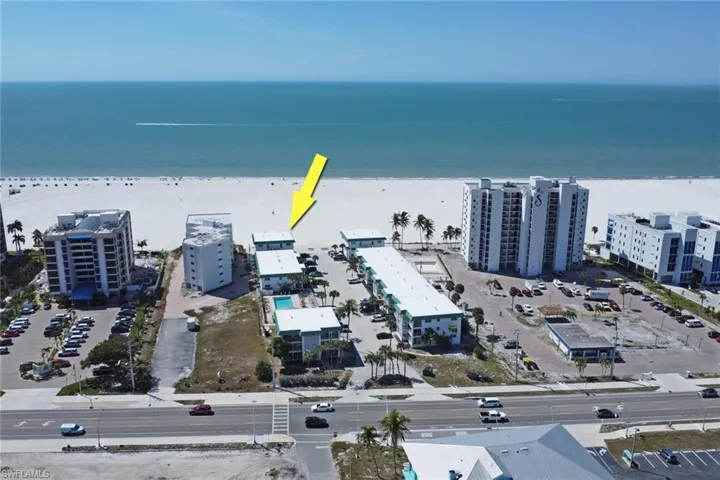 Aerial view of apartment complex and extended coastline