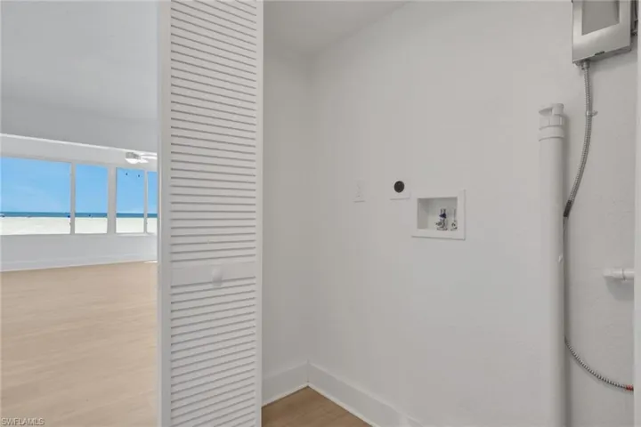 Laundry area featuring washer hookup, light wood-type flooring, and hookup for an electric dryer