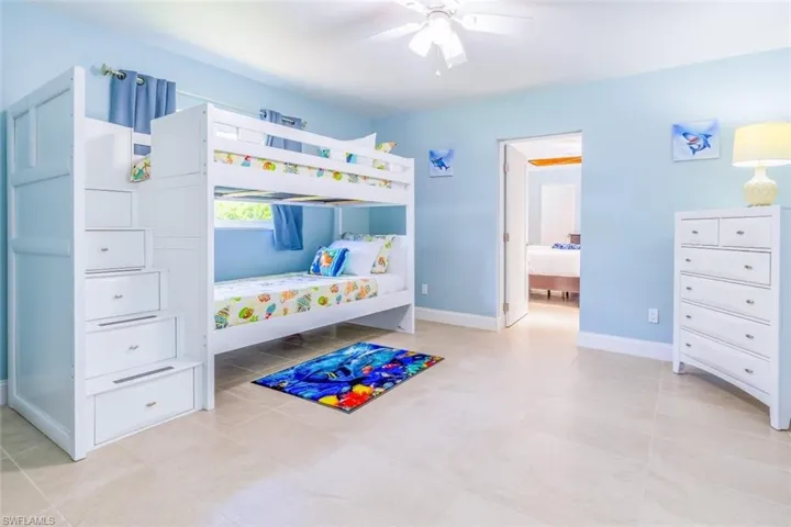 Light-toned tile flooring complements pale blue wall paint
