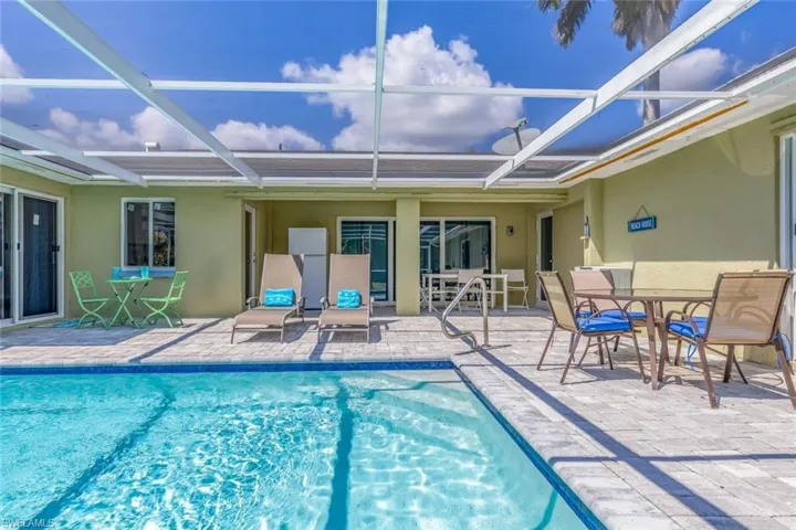Screened outdoor patio featuring a swimming pool, paver deck, and direct access to interior spaces