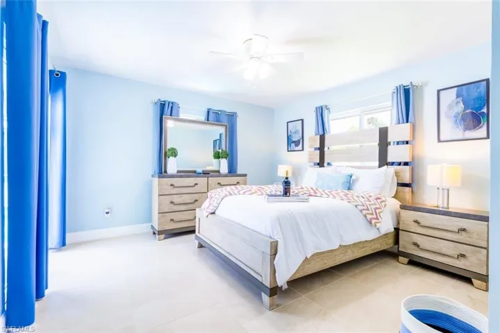 Bedroom featuring light tile flooring and light blue wall tones