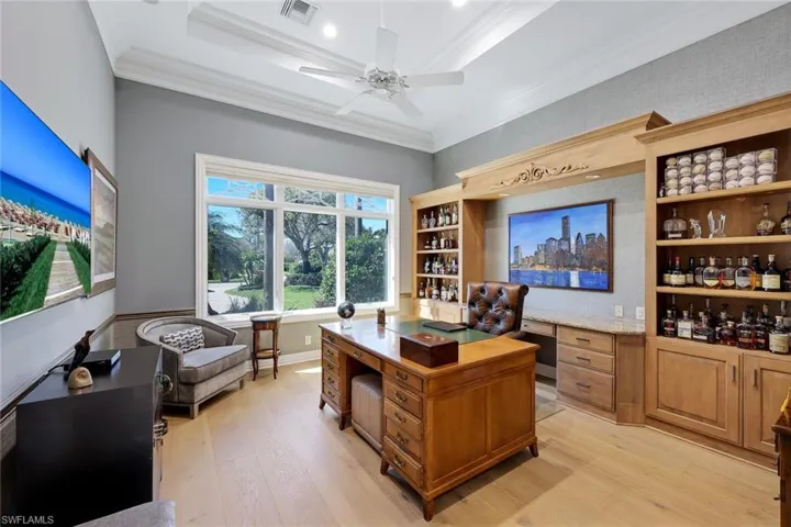 Den/study with custom built shelves and cabinetry.