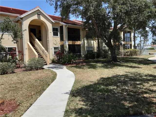 View of property's community featuring a lawn and stairway