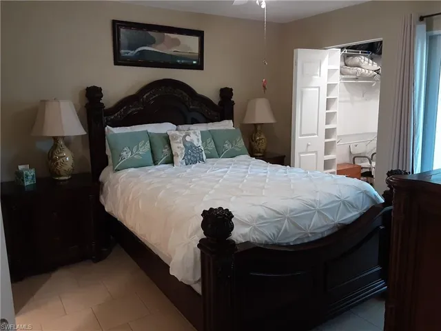 Bedroom featuring a walk in closet and light tile patterned floors