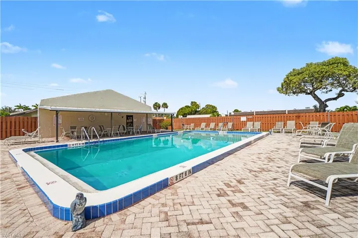 Community pool featuring a patio area & clubhouse.