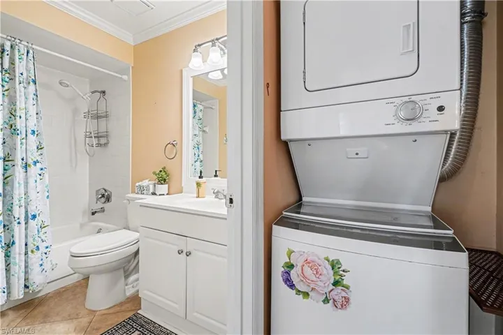 Washer/dryer located in the hallway by the guest bathroom.