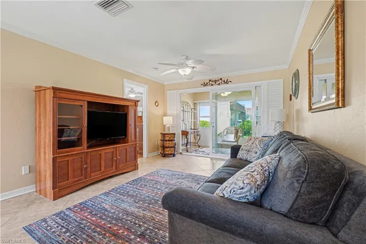 Living room with access to the primary bedroom & lanai.