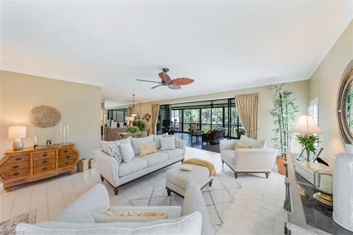 View of Living room thru to Florida room ( Furniture in Living room is excluded in the sale)
