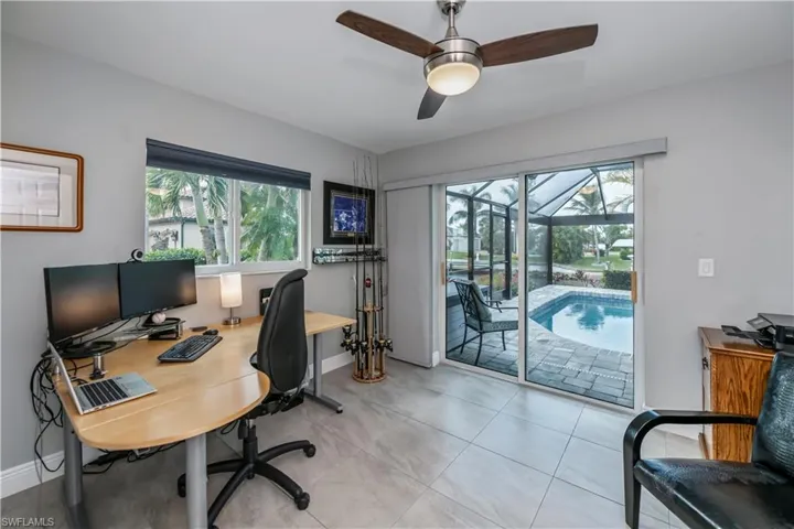 Third bedroom used as office with pocket sliding glass door to pool area