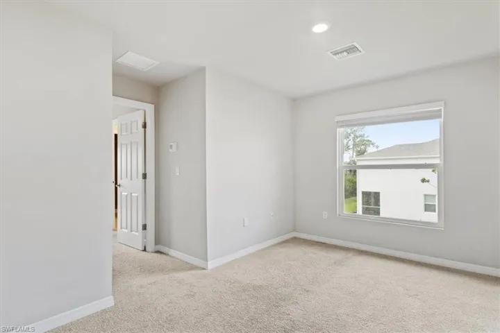 Unfurnished room featuring light colored carpet and recessed lighting