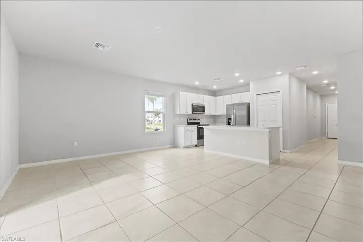 Unfurnished living room featuring light tile patterned floors and recessed lighting