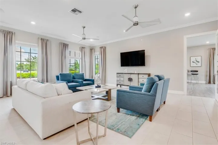 Living room featuring crown molding, a ceiling fan, and recessed lighting