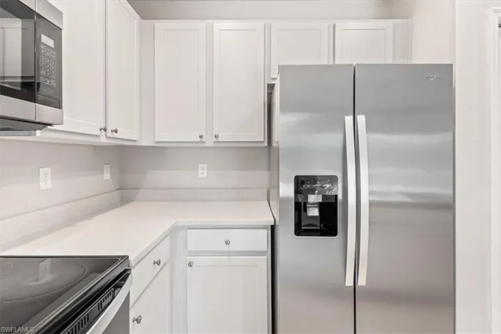 Kitchen with stainless steel appliances and white cabinetry