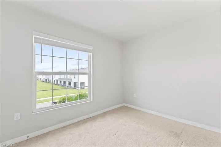 Spare room featuring baseboards and carpet flooring