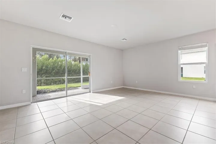 Unfurnished room featuring light tile patterned flooring