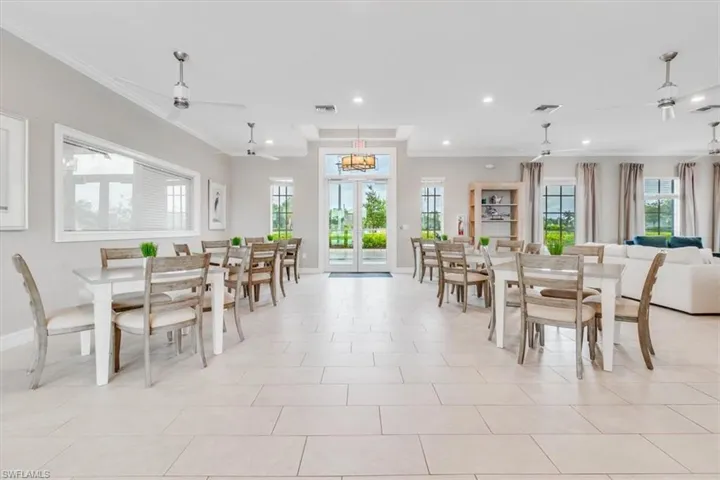 Dining space with french doors, ornamental molding, light tile patterned floors, and recessed lighting