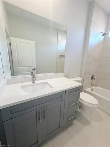 Full bath featuring vanity and shower / tub combination