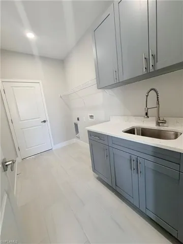 Laundry area featuring hookup for a washing machine, cabinet space, and hookup for an electric dryer