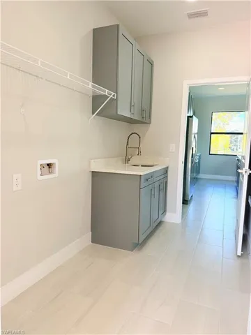 Laundry room featuring baseboards and hookup for a washing machine