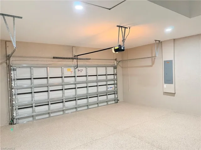 Garage with electric panel and a garage door opener