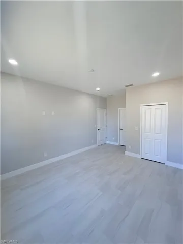 Unfurnished bedroom with recessed lighting and a closet