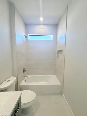 Bathroom with vanity and shower / tub combination