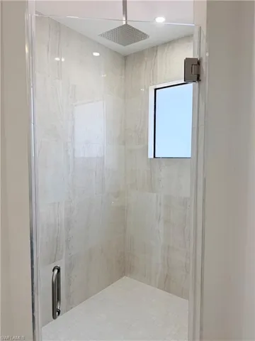 Bathroom with a marble finish shower