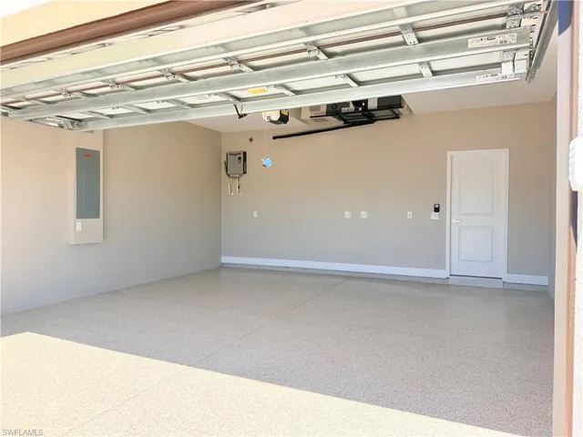 Garage with electric panel and tankless water heater