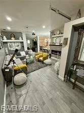 Living room with wood finished floors and a fireplace