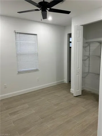 Unfurnished bedroom featuring ceiling fan, light hardwood / wood-style flooring, and a closet