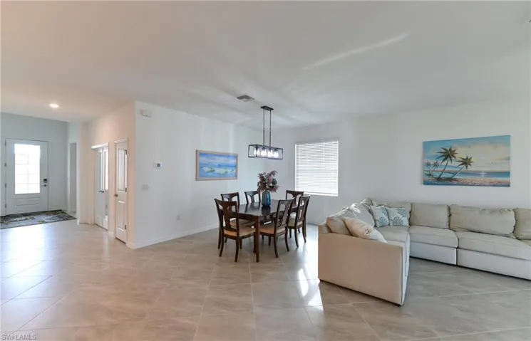 Living room with light tile patterned floors and baseboards