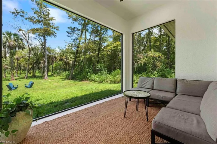 Screened lanai/porch featuring outside view of the property