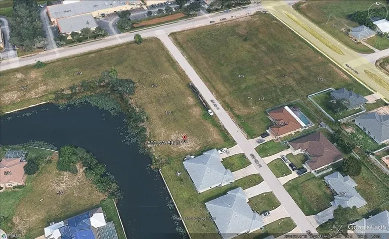 Vacant land parcel featuring canal frontage, street access, and a level buildable area
