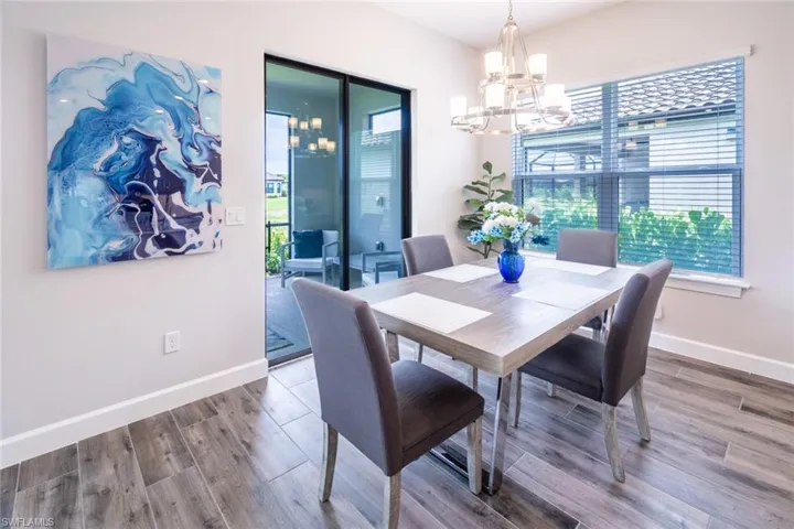 Dining space with an inviting chandelier and hardwood / wood-style floors