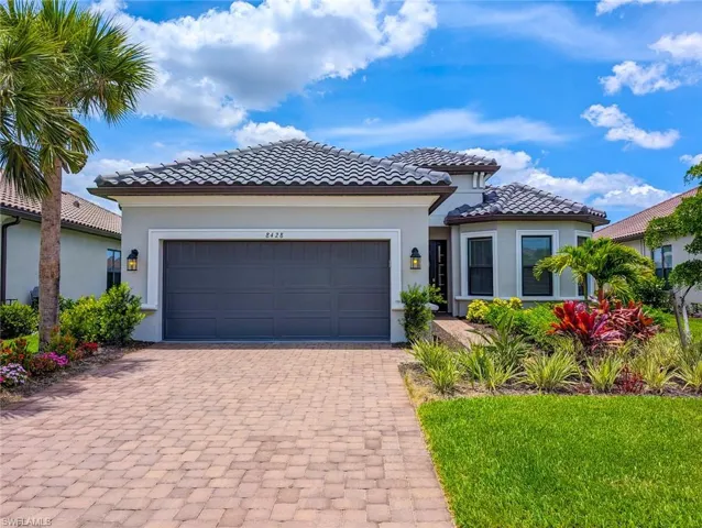 Mediterranean / spanish-style house with a garage