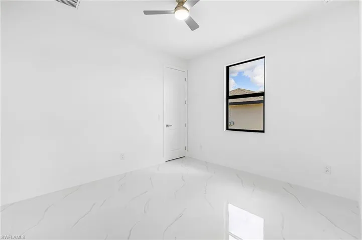 Unfurnished room featuring baseboards and a ceiling fan