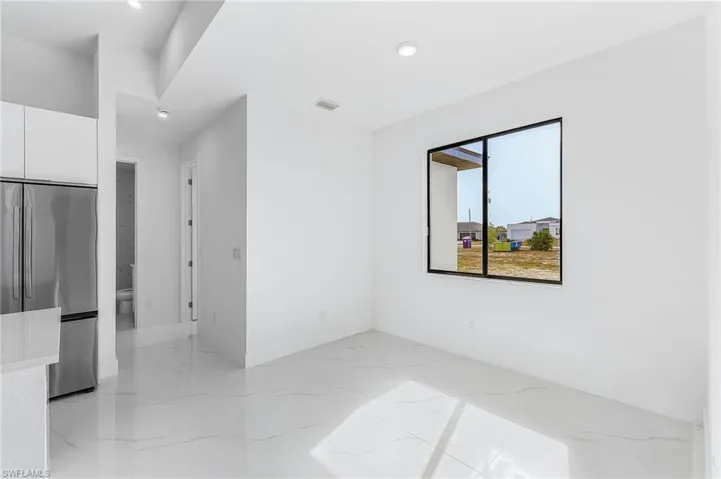Spare room featuring light marble finish flooring